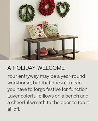 Image of an entryway bench with wool holiday pillows and red and green holiday wreaths hanging above. A HOLIDAY WELCOME: Your entryway may be a year-round workhorse, but that doesn’t mean you have to forgo festive for function. Tuck small holiday accessories like mini trees and holiday ornaments onto entry consoles. Layer colorful pillows on a bench or add lighted garland and a cheerful wreath to the door to top it all off. Don’t forget a scented candle will greet your guests with the smell of a cozy and nostalgic home.