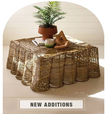 Image of Scalloped Woven Seagrass Ripple Coffee Table with fern potted plant on it. NEW ADDITIONS