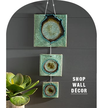 Lifestyle Image of Hanging Ceramic & Glass Wall Art on wall. SHOP WALL DECOR
