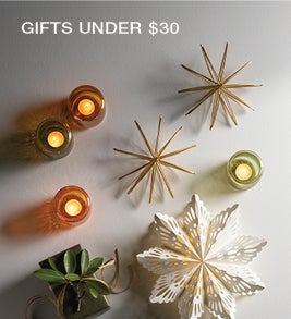 Image of paper and metal star ornaments and votive candle holders. Shop Gifts under $30.