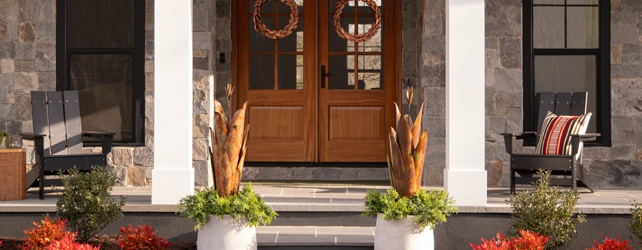 Image of pair of Copper-Finish Large Agave Stake Sculpture on front porch. SHOP PORCH + PATIO
