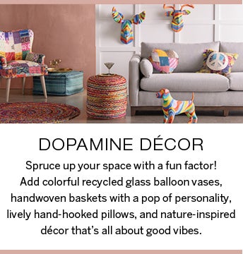 Image of brightly colored decor in living room setting. Dopamine Decor: Spruce up your space with a fun factor! Add colorful recycled glass balloon vases, handwoven baskets with a pop of personality, lively hand-hooked pillows, and nature-inspired decor that's all about good vibes.