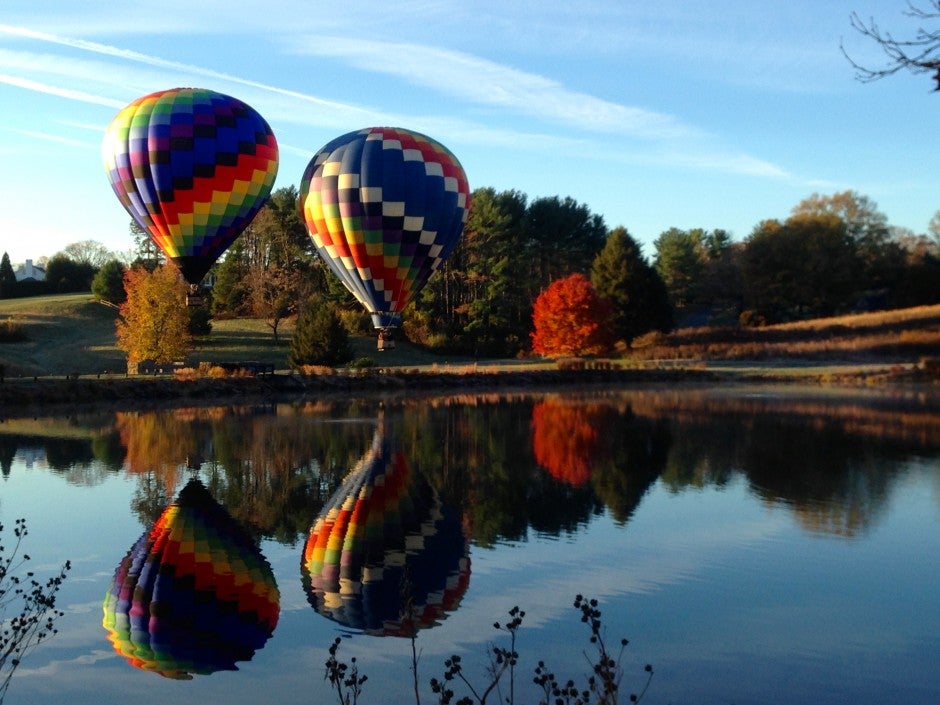 hot air balloons over lake